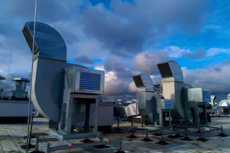Bright sun in thick blue clouds against a blue sky.の写真素材