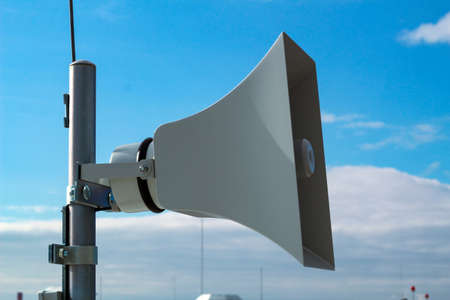 Loudspeaker of the emergency warning system against the background of a blue sky.の写真素材