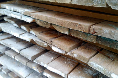 Stacked old boards covered with frost on a frosty dayの写真素材