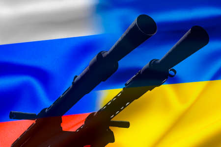 Military conflict between Russia and Ukraine, A gun against the background of two state flags of the warring states.の写真素材
