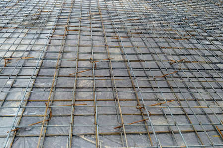 Preparation of the floor of an industrial building for pouring with concrete, installation of steel reinforcement.の写真素材