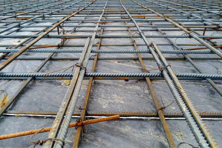 Preparation of the floor of an industrial building for pouring with concrete, installation of steel reinforcement.の写真素材