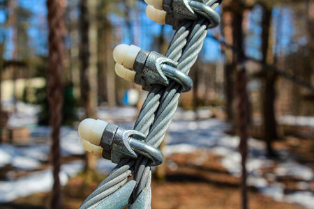 Fastening elements of the cable made of galvanized steel, couches, clamps. Fastening system for the rope park.の写真素材