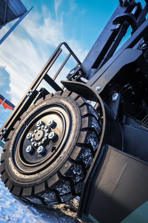 Close up of the wheel of a tractor covered with snow in winterの写真素材