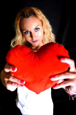 portrait of attractive caucasian smiling woman with heartの写真素材