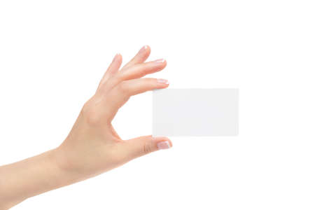Female hand holds white card on a white background.の写真素材