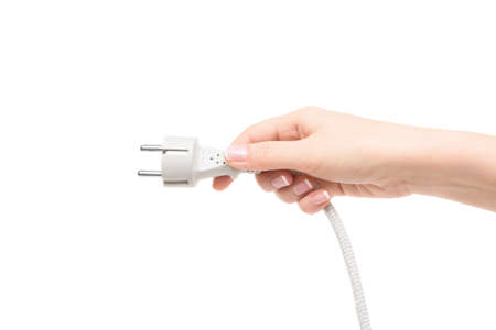 Female hand holds electric cable on a white background.の写真素材