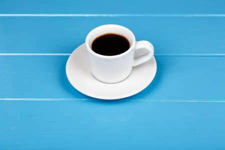 View of cup of black drink on blue wooden background.の写真素材