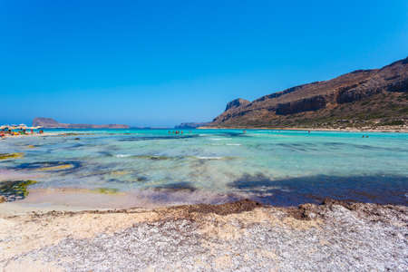 View of sunbathing people on gritty beach of Balos lagoon on Crete. Greece.の写真素材