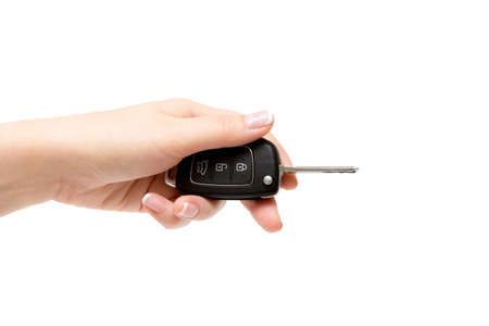 Female hand holds car keys.