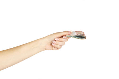 Isolated female hand holds russian money on a white background.の写真素材
