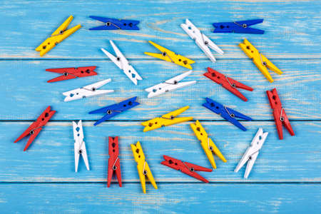 View of colored clothespins on a blue backgroundの写真素材