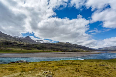 The river and mountains under cloudy sky in Icelandの写真素材