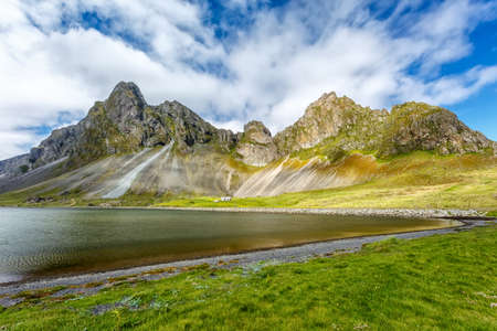 View of the lake on a background of mountains under clouds in Iceland