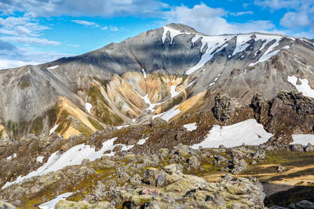 View of mountains in Landmannalaugar valley under cloudy sky in Icelandの写真素材