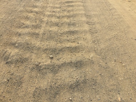 The road from gravel as background, soil as texture, wavy country roadの写真素材