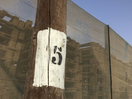 numeral five, black number five on a white background, number on a column, dense mesh as a backgroundの写真素材