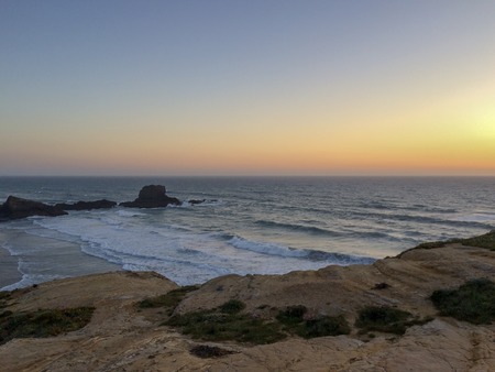 Foaming waves, Atlantic waters, sunset, rocks by the sea, coastal line, twilight, plantsの写真素材