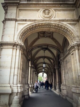 Austria, Vienna, 15/04/2017 people pass under the arches, old building with a lot of decor elements