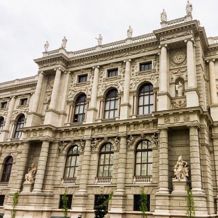 Beautiful building with large windows, beautiful building, cloudy weather, lot of sculptures and stuccoesのeditorial素材