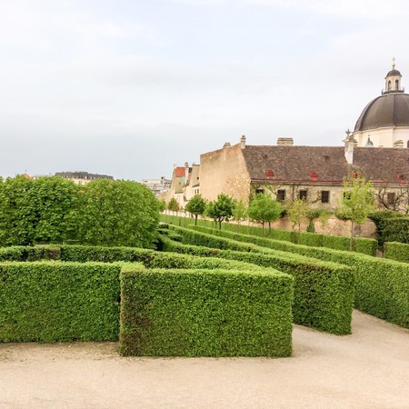 hedge and sculpture in the park, white sculptures in the park on the background of a green labyrinth of hedgerowsのeditorial素材