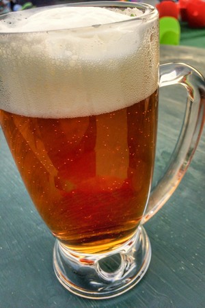 beer mug on the table, foam on the beer, black tableの写真素材