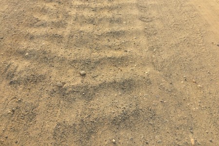 road from gravel as background, soil as texture, wavy country roadの写真素材