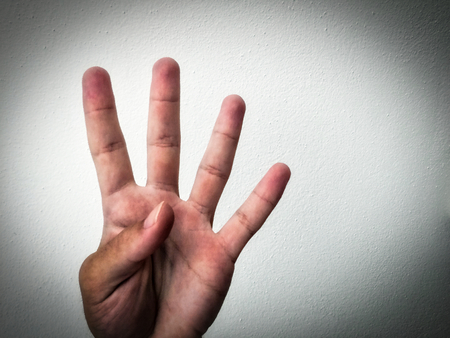 outstretched palm, hand on a white background, part of the body, part of the hand, white skin, four fingers, show the amountの写真素材