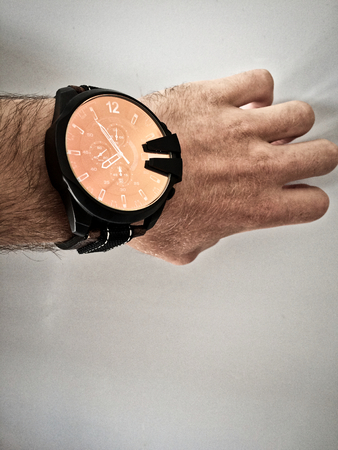 watch on the arm, part of the body, white skin, white background, hair on the arm, part of the hand, look at what timeの写真素材
