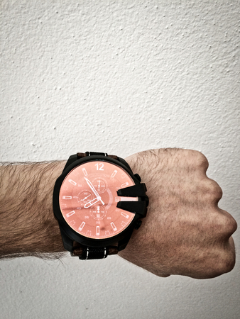 make a fist, watch on the arm, part of the body, white skin, white background, hair on the arm, part of the hand, watch what time it isの写真素材