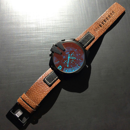 wrist watch with leather strap on a dark background, watch on a dark background, dial, clock hands,...