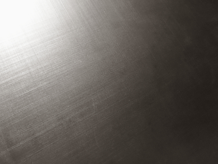 corrugated metal alloy as a background, metal surface, aluminum alloy, magnesium alloy, sun flare, grainy textureの写真素材