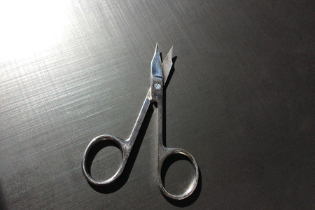 small nail scissors on a dark background, nail scissors, small scissors, dark backgroundの写真素材