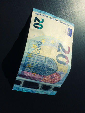 banknote of twenty euros on a dark background, money on a dark background, european currency, twenty euros, banknote, paper moneyの写真素材