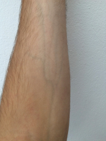 male forearm, protruding veins, hair on the arm, white skin, white backgroundの写真素材