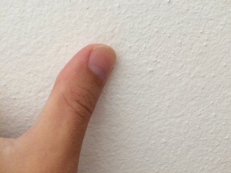 thumb, one finger, thumb on a white backgroundの写真素材
