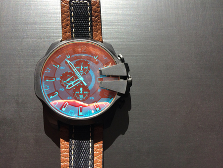 wrist watch with leather strap on a dark background, watch on a dark background, dial, clock hands, wrist watchesの写真素材
