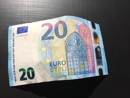 banknote of twenty euros on a dark background, money on a dark background, european currency, twenty euros, banknote, paper moneyの写真素材