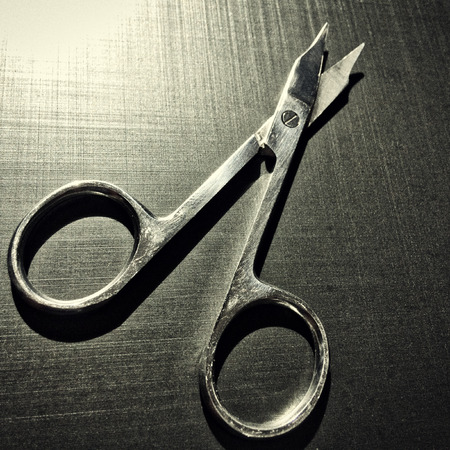 small nail scissors on a dark background, nail scissors, small scissors, dark backgroundの写真素材