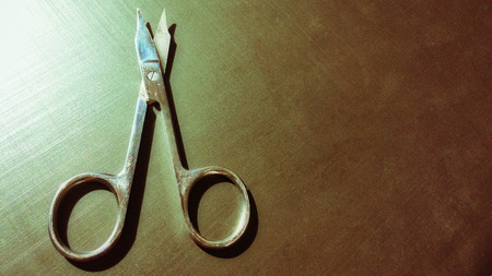 small nail scissors on a dark background, nail scissors, small scissors, dark backgroundの写真素材