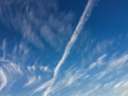 trail from the plane in the blue skyの写真素材