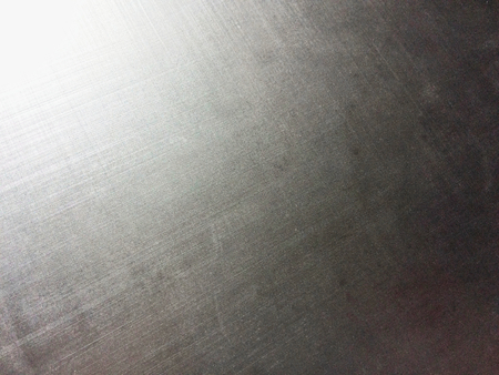 corrugated metal alloy as a background, metal surface, aluminum alloy, magnesium alloy, sun flare, grainy textureの写真素材