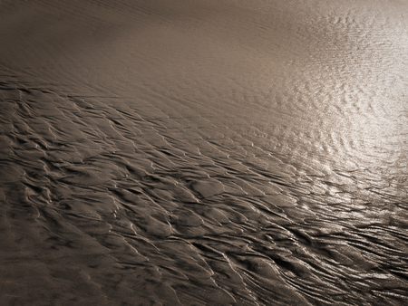 patterns created Ð¾n the sand by waves and wind, sand pattern as backgroundの写真素材