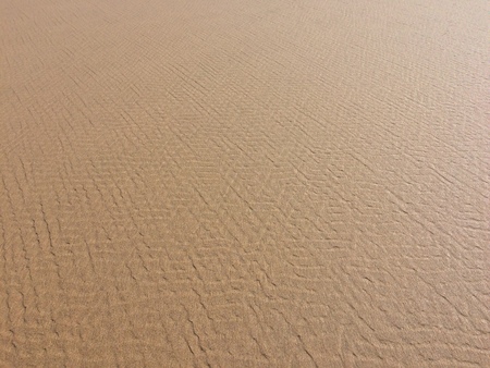 patterns in the sand from the waves and wind, sea sand as a background