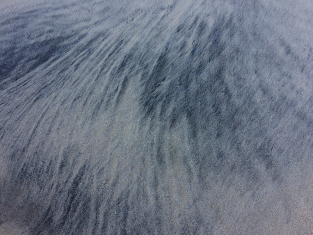 sea silt in the sand, patterns in the sand left by the wavesの写真素材