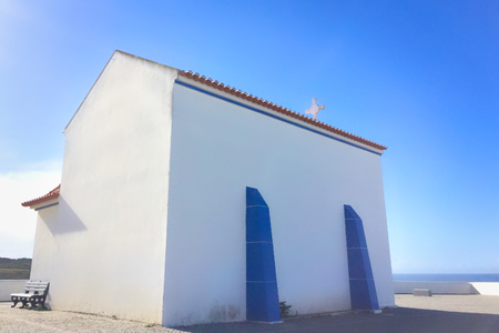 small white church in portugal on a sunny day, blue sky, combination of white and blue, place of prayer, religious buildingの写真素材