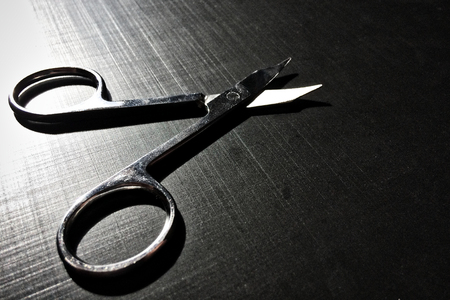 small nail scissors on a dark background, nail scissors, small scissors, dark backgroundの写真素材