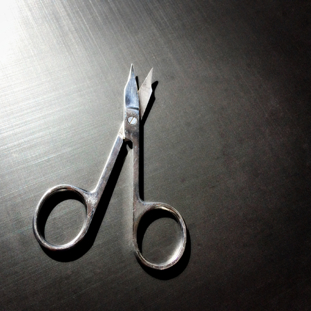 small nail scissors on a dark background, nail scissors, small scissors, dark backgroundの写真素材