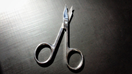 small nail scissors on a dark background, nail scissors, small scissors, dark backgroundの写真素材