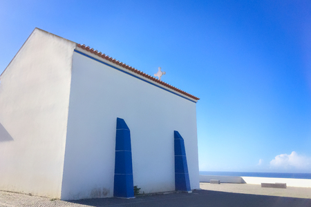 small white church in portugal on a sunny day, blue sky, combination of white and blue, place of prayer, religious buildingの写真素材